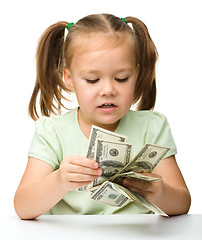 Image showing Cute little girl with paper money - dollars