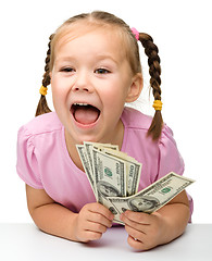 Image showing Cute little girl with paper money - dollars