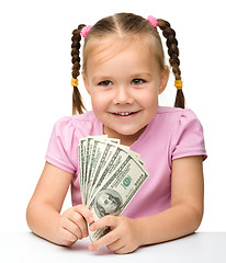 Image showing Cute little girl with paper money - dollars