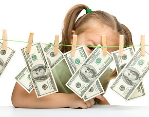 Image showing Cute little girl with paper money - dollars