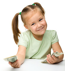 Image showing Cute little girl with paper money - dollars