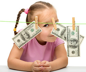 Image showing Cute little girl with paper money - dollars