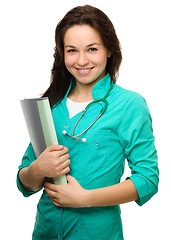 Image showing Young attractive woman wearing a doctor uniform