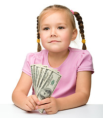 Image showing Cute little girl with paper money - dollars