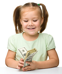 Image showing Cute little girl with paper money - dollars