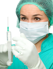 Image showing Young nurse is preparing syringe for injection