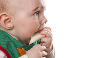 Image showing baby sitting and eating an apple