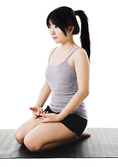 Image showing Chinese woman doing yoga.