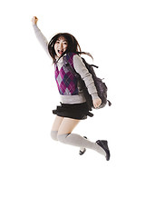 Image showing Chinese school girl jumping into air.