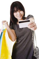 Image showing Chinese woman holding shopping bags and credit card.