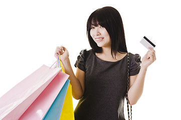 Image showing Chinese woman holding shopping bags and credit card.