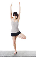 Image showing Chinese woman doing yoga.