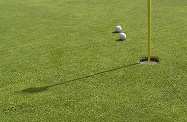 Image showing hole and golf balls in green back