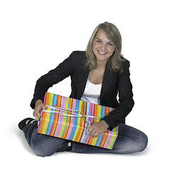 Image showing sitting cute girl with present