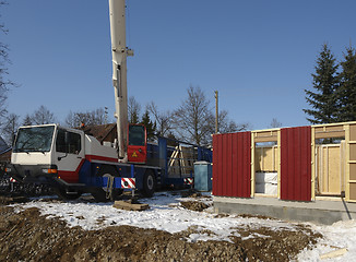 Image showing wooden house construction in sunny ambiance