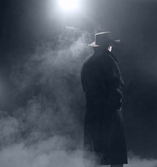 Image showing Woman wearing trench coat and standing in fog