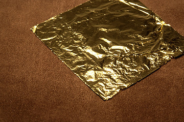 Image showing beaten gold in brown suede back