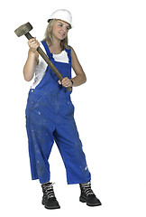 Image showing girl dressed in workwear holding a big hammer