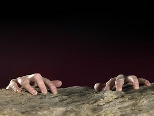 Image showing clutchin hands on stone surface