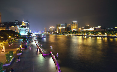 Image showing Aerial image of a modern city by a river 