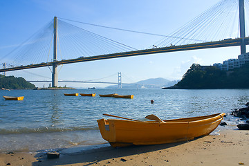 Image showing boat on the beach under the bridge