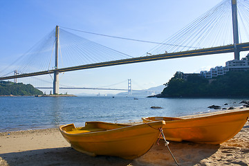 Image showing boat on the beach under the bridge