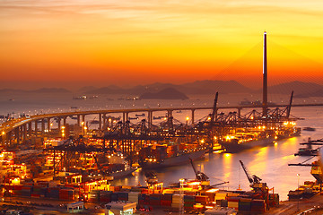 Image showing Port warehouse with cargoes and containers at sunset 