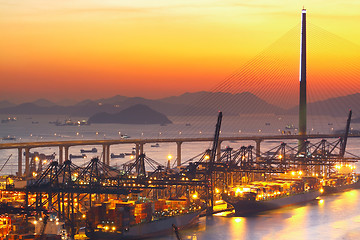 Image showing Port warehouse with cargoes and containers at sunset 