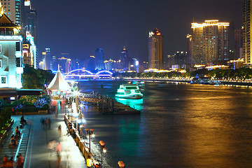 Image showing Aerial image of a modern city by a river 