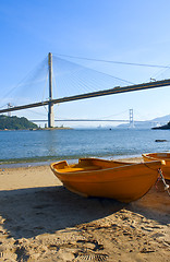 Image showing boat on the beach under the bridge