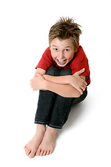 Image showing Sitting child in jeans and t-shirt