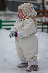 Image showing Little girl plays with snowball