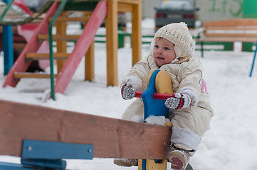 Image showing Little girl sits on the swing