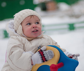 Image showing Little girl sits on the swing