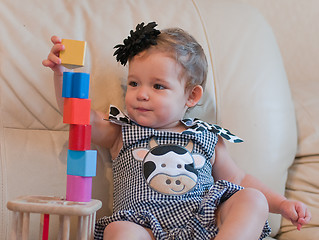 Image showing Little girl plays with cubes