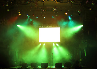 Image showing empty stage and screen in the rays of light