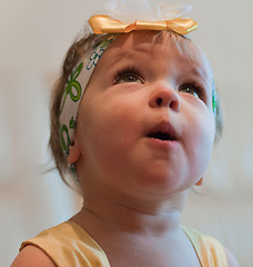 Image showing Little surprised girl looks up