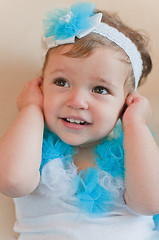 Image showing Little girl in the blue dress closes her ears