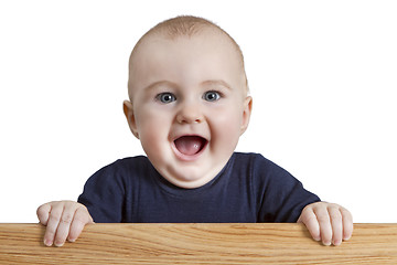 Image showing young child holding wooden board