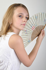 Image showing beautiful girl with a fan