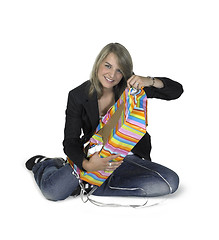 Image showing sitting cute girl unwrapping a present