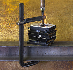 Image showing burning vise and hard disks