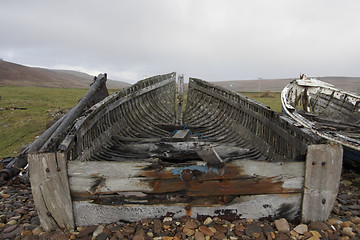 Image showing coastal scenery with small rotten boat