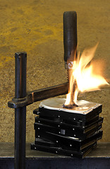 Image showing burning vise and hard disks