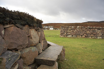 Image showing idyllic bench and stone wall