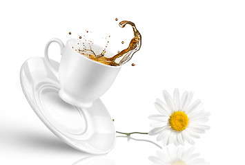 Image showing Splash of tea in the falling cup with flower isolated on white 
