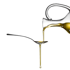 Image showing Pouring oil on spoon isolated on white