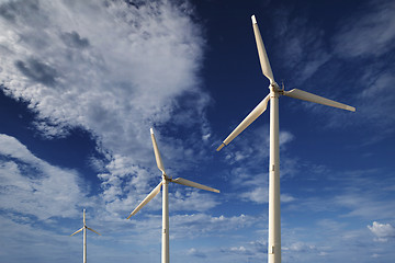 Image showing Wind turbines against a blue sky