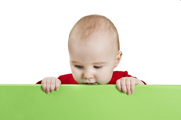 Image showing young child holding green shield