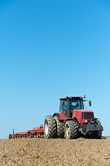 Image showing Ploughing tractor at field cultivation work